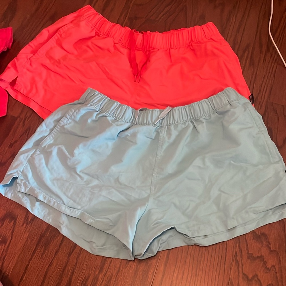 Two pairs of Patagonia women’s outdoor shorts, size large, light blue and orange
